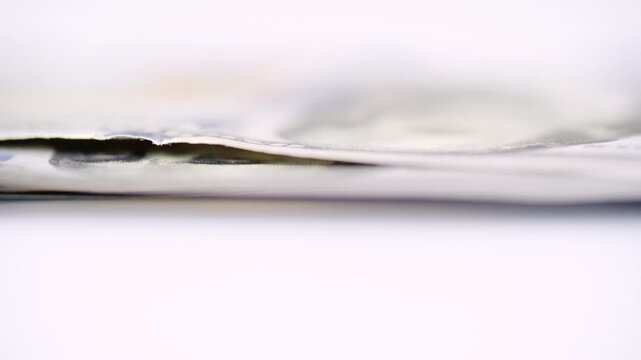 Low angle layered dollar profile rising from surface, entrepreneur stacks notes during startup hustle, shallow focus captures thin edges and subtle motion blur, energetic growth