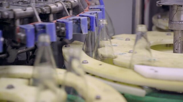 Industrial conveyor system cleaning glass bottles for beverages