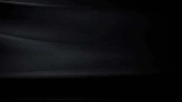 Black textured surface background with subtle light reflections for modern design and technology use