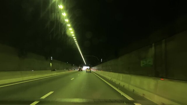Amsterdam Netherlands highway, Night traffic moving through an illuminated road tunnel