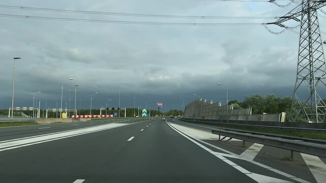Amsterdam Netherlands highway, Curved motorway under cloudy sky