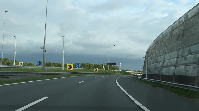 Amsterdam Netherlands highway, Curving empty highway beside a concrete sound barrier