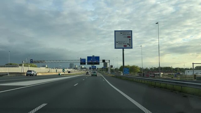 Amsterdam Netherlands highway, Empty urban motorway beneath cloudy sky with clear lanes, barriers