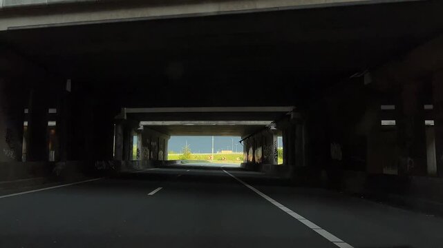Amsterdam suburbs, Amstelveen, Sunlit suburban Dutch underpass seen from a driver's perspective