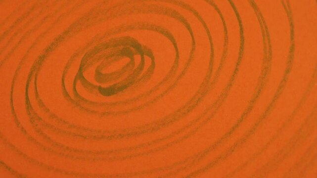 Rotation of scribbles on an orange paper