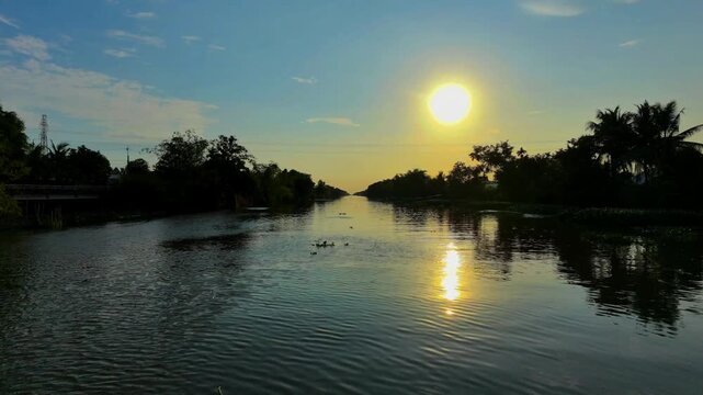 Bright afternoon sunset reflection on a peaceful countryside river