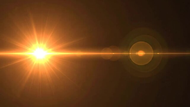A bright golden light flare shines across a dark background