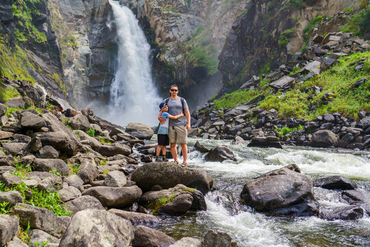 father and son visit the Kurkure waterfall