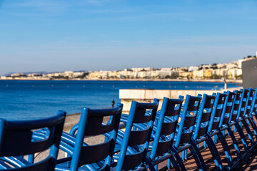 Fototapeta premium Blue chairs on the Promenade des Anglais in Nice, France.