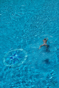 A girl swims in a pool at a hotel in Palma de Mallorca, Spain.