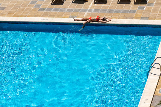 A girl sunbathes by the pool at a hotel in Palma de Mallorca, Spain.