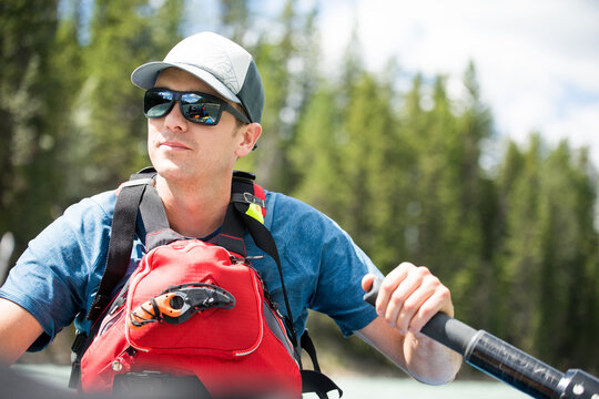 Young man enjoying a day kayaking on a river