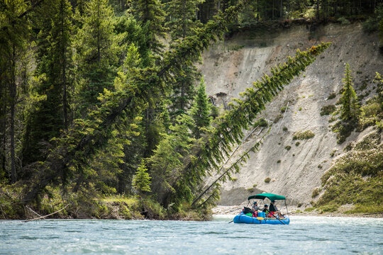 People on an inflatable raft float down a river