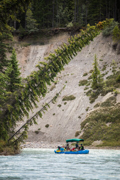 Group of friends on a scenic river raft trip
