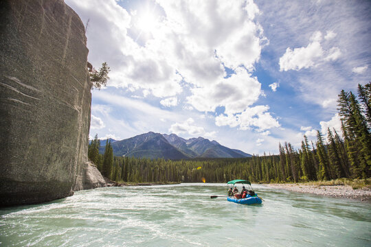 People rafting on a scenic mountain river