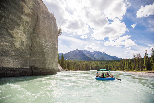 People rafting on a scenic mountain river