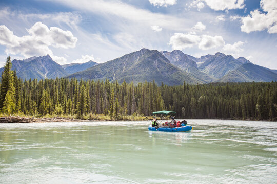 Group of friends floating down a scenic mountain river