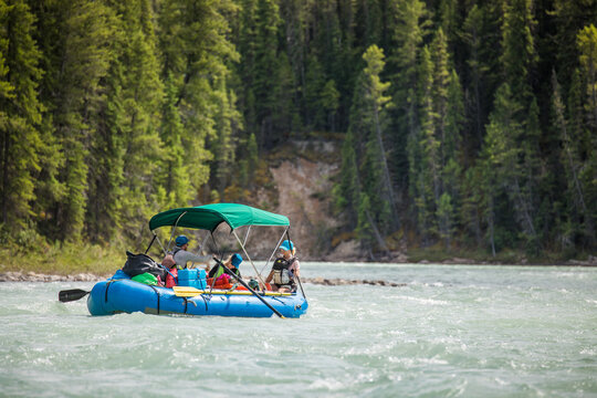Group of people rafting on a scenic forested river