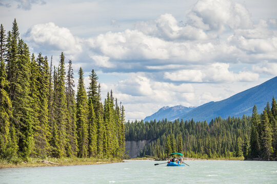 A group of people rafting on a scenic mountain river