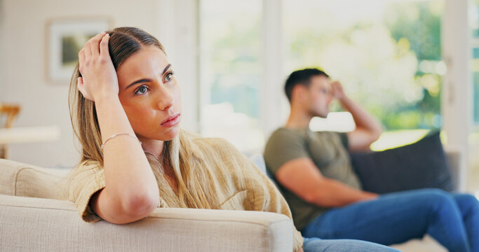 Stress, argument and woman on sofa in home for conflict, breakup or cheating problem in marriage. Upset, couple and female person in living room with fighting, divorce or toxic relationship in house.