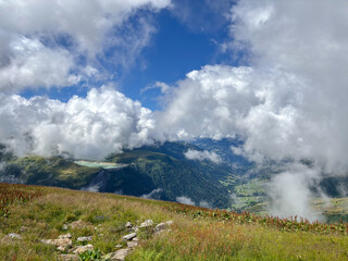 Obraz premium Cloudy alpine valley view from mountain meadow in Les Contamines-Montjoie, France