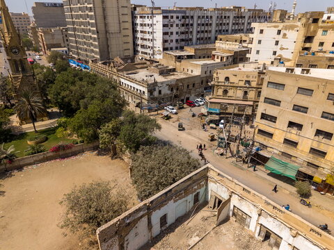 Aerial view of I.I. Chundrigar Road featuring historic architecture, a prominent clock tower, and dense urban streets in Karachi, Sindh, Pakistan.