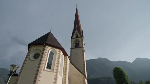 Historic church architecture in Umhausen Tyrol Austria set among alpine landscapes of Oetz Valley featuring mountain village charm and travel in Europe
