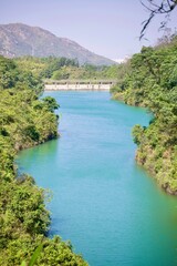 A scenic view of the emerald green waters and concrete dam at Wong Nai Tun Reservoir in Hong Kong.  © Eric Au