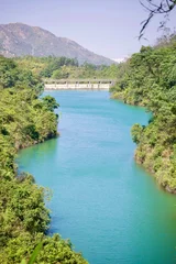 Fotobehang Slaapkamer A scenic view of the emerald green waters and concrete dam at Wong Nai Tun Reservoir in Hong Kong.   © Eric Au
