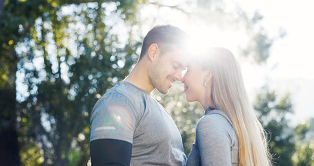 Fototapeta premium Fitness, nature and couple with forehead touch for exercise, bonding and support for morning workout. Happy, flare and man with woman for affection outdoor in park for sports, active or health,
