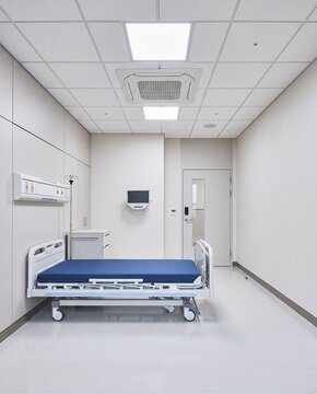 Minimal hospital patient room with blue bed