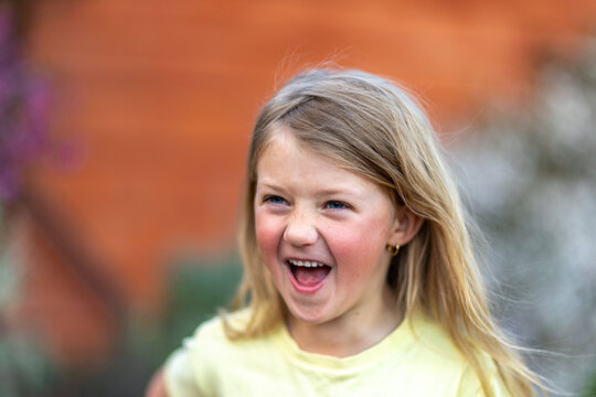 Child laughing joyfully during outdoor playtime