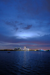 Fototapeta premium City skyline across water at blue hour