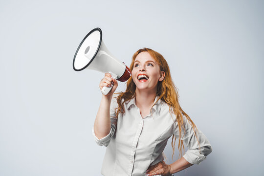 A woman with a megaphone. Promotion, action success business with isolated free copy space background.