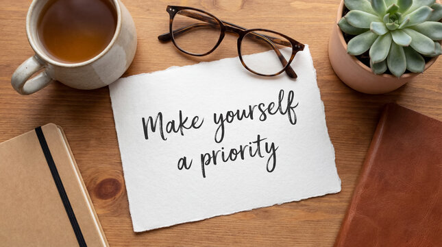 Self care message make yourself a priority on paper, finding balance and well being in a personal workspace setup