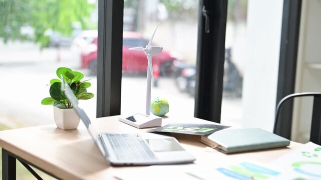 Esg concept with wind turbine model on desk