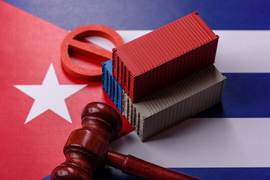 The cargo container ban on the Cuba flag as a conceptual backdrop. The cargo container embargo