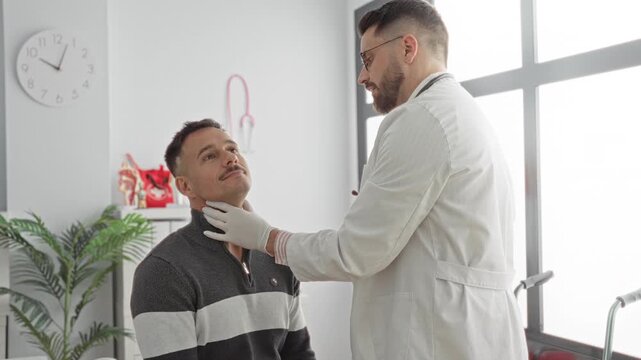 Doctor in white coat palpates male patient's throat and jaw while the seated man looks upward in a medical building consultation room; reassurance professional care.