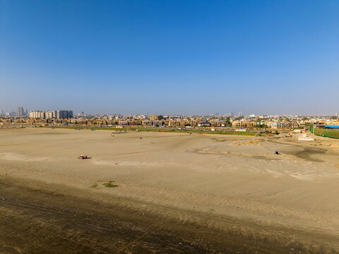 Aerial view of the sandy expanse of Sea-View Beach with the urban skyline in the background, Karachi, Sindh, Pakistan.