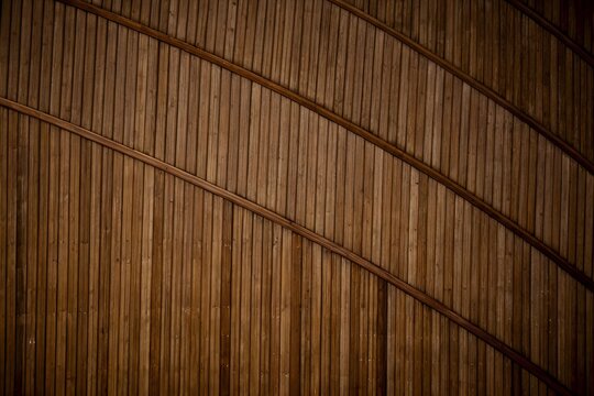 Walnut brown vertical bamboo slats wall panel background