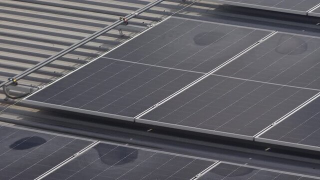 Water puddle and stains on solar panels are mineral deposits left when rainwater evaporates, caused by too low of a tilt angle for proper drainage.