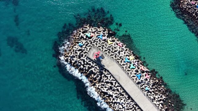 Aerial view of a breakwater extending into the sea on a clear day in South Korea