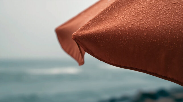 Wet terracotta beach umbrella close-up with minimalist seaside mood, soft copy space, and premium summer vacation concept for travel branding.