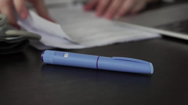 ozempic pen medical injection hand blue gloves desk background, professional preparing diabetes medication for patient treatment, clinical setup, concept of healthcare support and wellness management