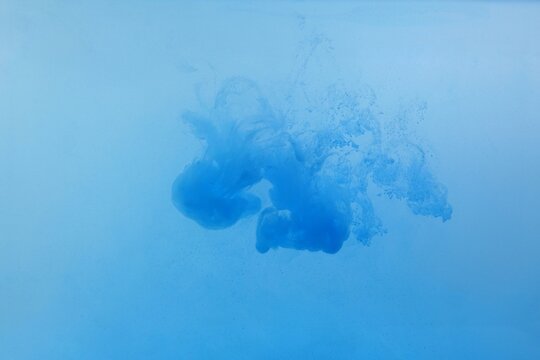Blue color dye melt on white background,Abstract smoke pattern,Colored liquid dye,Splash pain