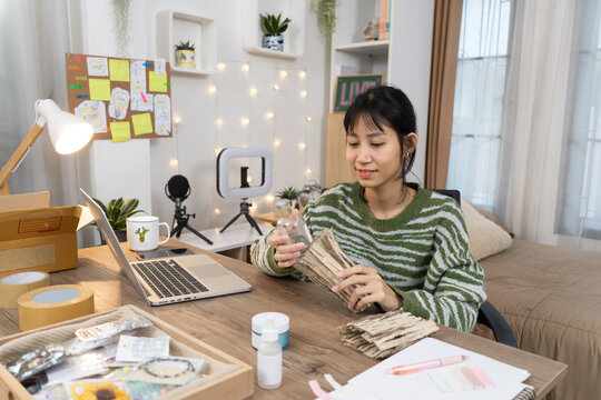 Young small business owner prepares product packaging for Shipping online customer orders in home studio