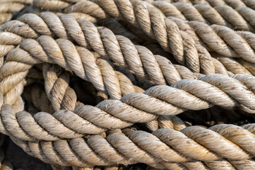 Fototapeta premium Thick marine rope coiled on a concrete pier