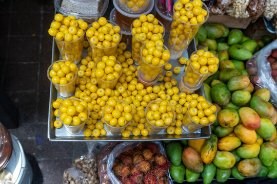 Fresh Nance Fruit in Plastic Cups at a Traditional Mexican Market