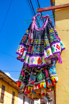 Colorful traditional Andean skirts hanging in Cusco, Peru