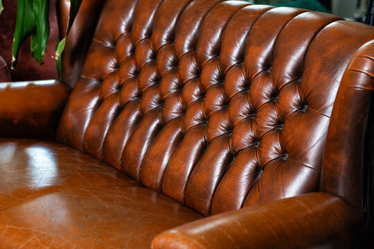 Classic brown leather Chesterfield sofa close up